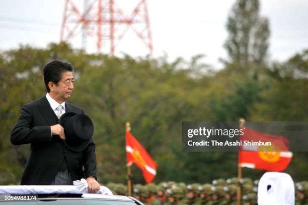 Japanese Prime Minister Shinzo Abe reviews during the Japan's Ground Self-Defense Force annual review at the Japan Ground Self Defense Force Camp...