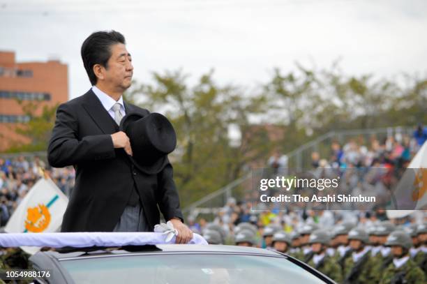 Japanese Prime Minister Shinzo Abe reviews during the Japan's Ground Self-Defense Force annual review at the Japan Ground Self Defense Force Camp...