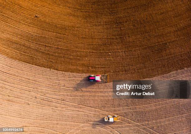 aerial view with drone of tractor plowing the land in the countryside. - drone agriculture bildbanksfoton och bilder