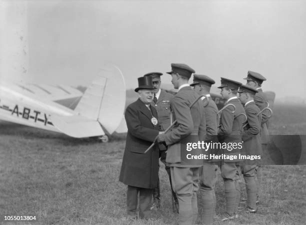 Visiting dignitary meeting airmen at Heston Aerodrome, Hounslow, London, circa 1933-circa 1935. The plane in the background is a Spartan Cruiser...