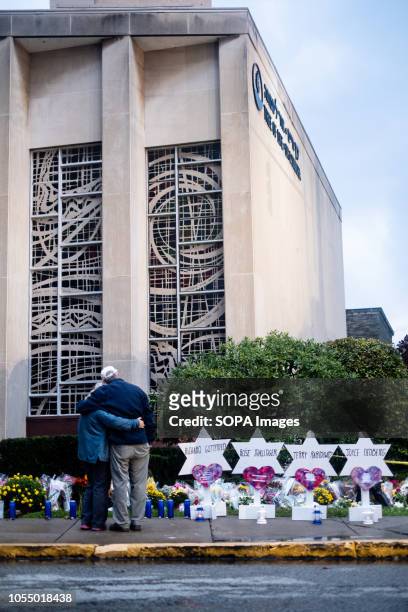 Mourners seen hugging in front of the makeshift memorial at the site of the mass shooting. After the tragic shooting in Pittsburgh, PA at the Tree of...