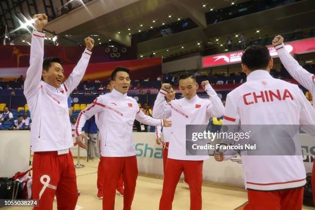 Team China celebrate after their team win the Men's Team Final during day 5 of the 2018 FIG Artistic Gymnastics Championships at Aspire Dome on...