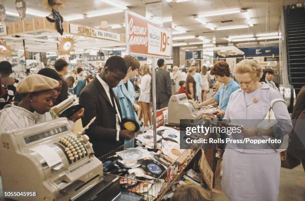 View of male and female, black and white customers browsing through records and other consumer goods in a department store in central Johannesburg,...