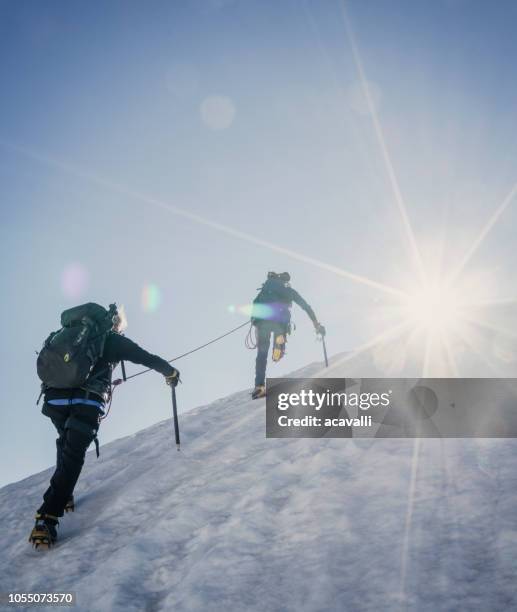 climbers on a snowy slope. - climbing snow mountain imagens e fotografias de stock