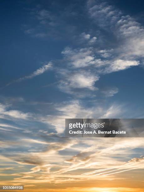 full frame of the low angle view of clouds in sky during sunset. - sunset with jet contrails stock pictures, royalty-free photos & images