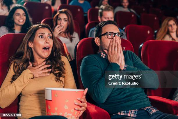 couple shouting in fear at cinema - woman watching horror movie stock pictures, royalty-free photos & images