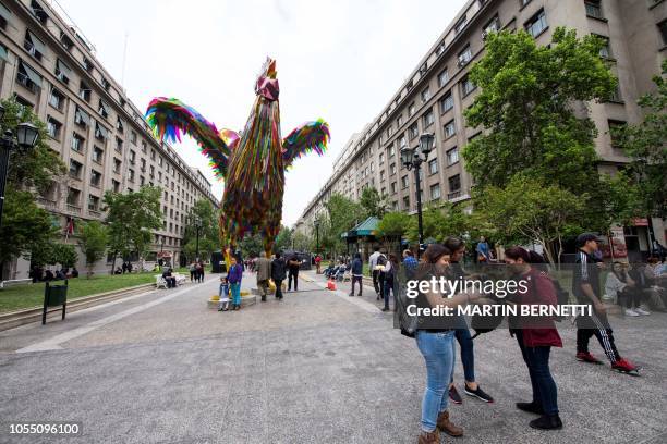 Colourful four-metre-high rooster made by artists Simone Chua from China and Renzo Barriga from Peru is seen on a pedestrian walk as part of the...