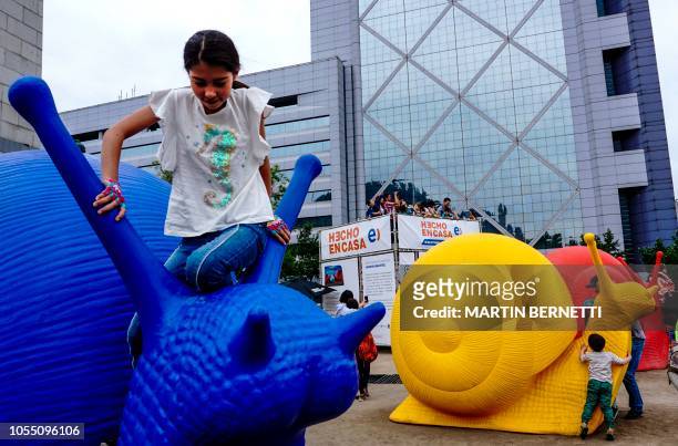 Land snails models made from recycled plastic by the collective of artists Cracking Art Group which originated in Italy, are seen on a pedestrian...