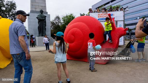 Land snails models made from recycled plastic by the collective of artists Cracking Art Group which originated in Italy, are seen on a pedestrian...