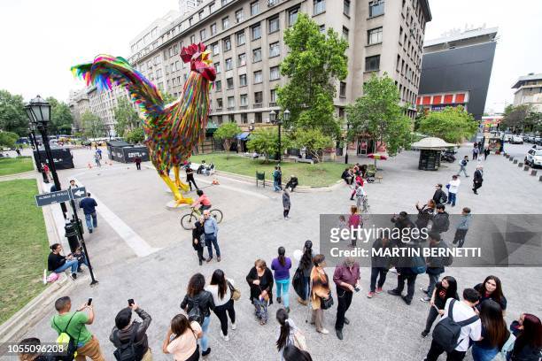 Colourful four-metre-high rooster made by artists Simone Chua from China and Renzo Barriga from Peru is seen on a pedestrian walk as part of the...