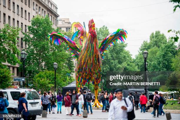 Colourful four-metre-high rooster made by artists Simone Chua from China and Renzo Barriga from Peru is seen on a pedestrian walk as part of the...