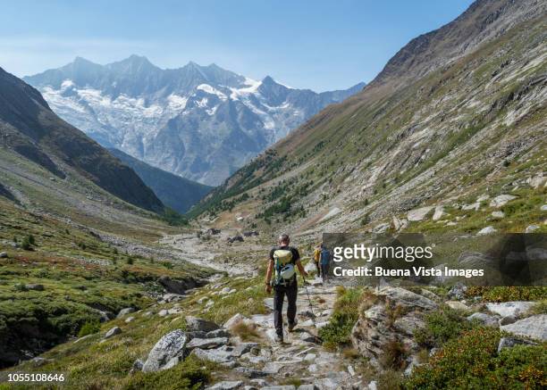senior climber on a mountain trail - monte rosa fotografías e imágenes de stock