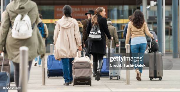 passengers with suitcasses - crowded airport stock pictures, royalty-free photos & images