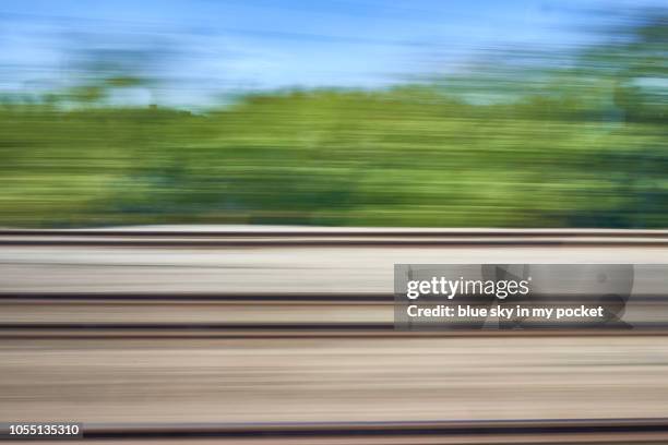 abstract blurred motion, from the widow of a fast moving train. - fast motion stock pictures, royalty-free photos & images