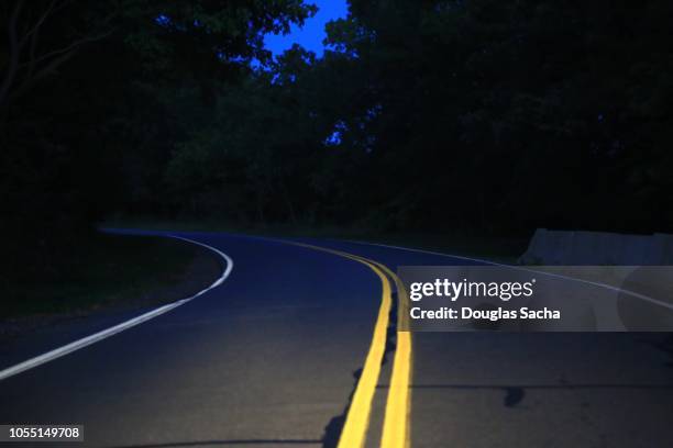 country highway in the night - winding road night stock pictures, royalty-free photos & images