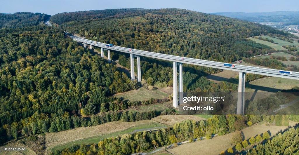 Highway bridge through forestland - aerial view