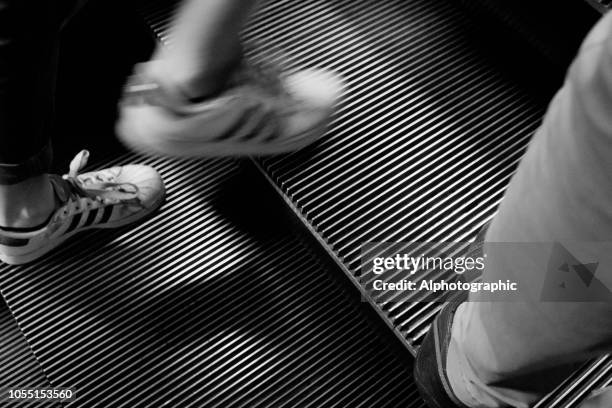 passenger on the escalators in london underground - adidas shoes stock pictures, royalty-free photos & images