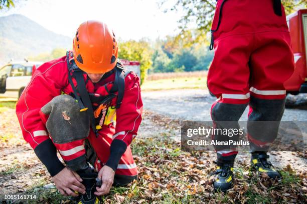 firefighters in a dry suit preparing for the rescue operation by the river - hurricane preparedness stock pictures, royalty-free photos & images