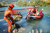 Dam construction on the river - rescue operation with a boat, oil spill
