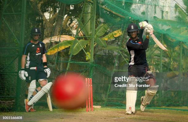 England batsman Ben Foakes cuts a ball as Ollie Pope looks on during England nets at the NCCC on October 29, 2018 in Colombo, Sri Lanka