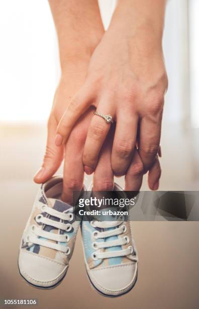 happy couple expecting baby - baby boot stock pictures, royalty-free photos & images