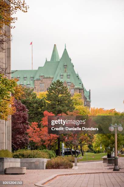 colourful autumn leaves in front of the parliament buildings in ottawa - ottawa skyline stock pictures, royalty-free photos & images