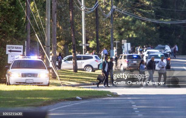 Parents walked to go pick up their kids outside Butler High School after the scene was considered safe in Matthews, N.C. On Monday, Oct. 29, 2018.
