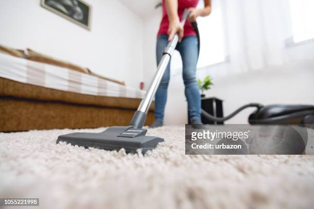 young woman vacuuming house - carpet stock pictures, royalty-free photos & images