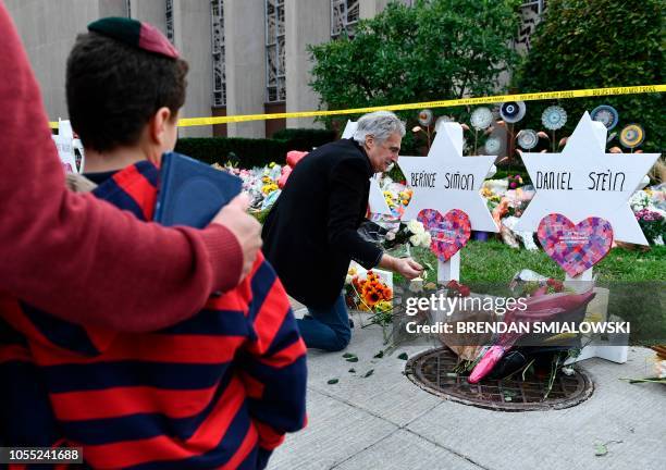 People pay their respects at a memorial outside the Tree of Life synagogue after a shooting there left 11 people dead in the Squirrel Hill...