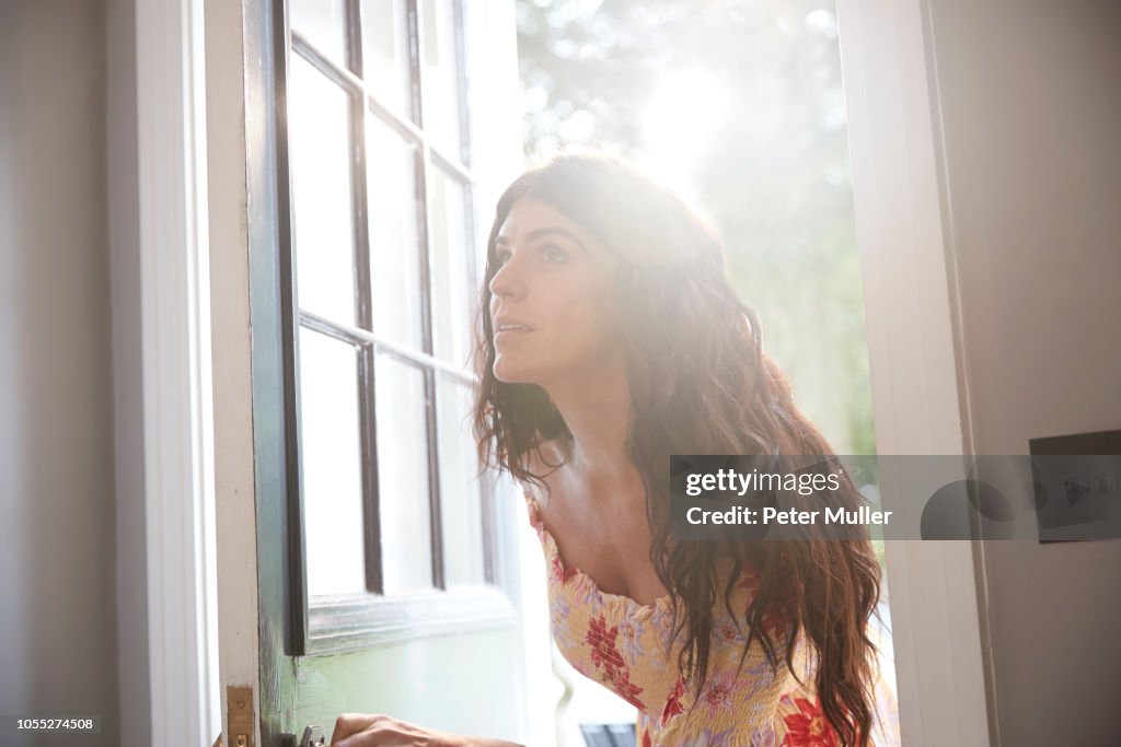 Stylish woman entering hotel doorway