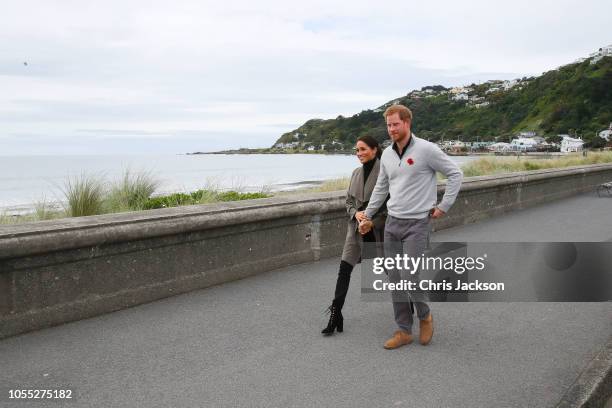 Prince Harry, Duke of Sussex and Meghan, Duchess of Sussex walking along Lyall Bay to visit Maranui Cafe on October 29, 2018 in Wellington, New...