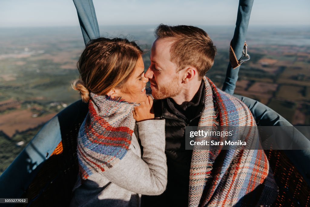 Newly engaged couple in hot air balloon