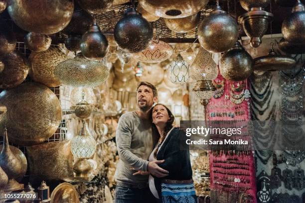 pregnant couple in souk, marrakech, morocco - morrocco stock pictures, royalty-free photos & images