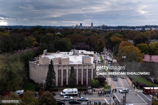 People pay their respects at a memorial outside the Tree of Life synagogue following the shooting that left 11 people dead in the Squirrel Hill...