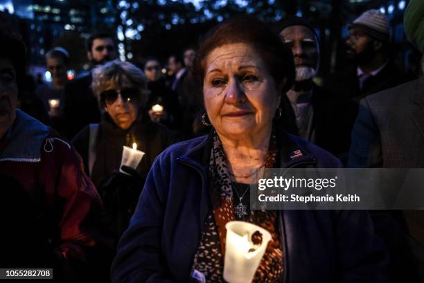 Sarah Goodman, a local Queens resident, participates in a candle light vigil in memory of the victims of the mass shooting at the Tree Of Life...