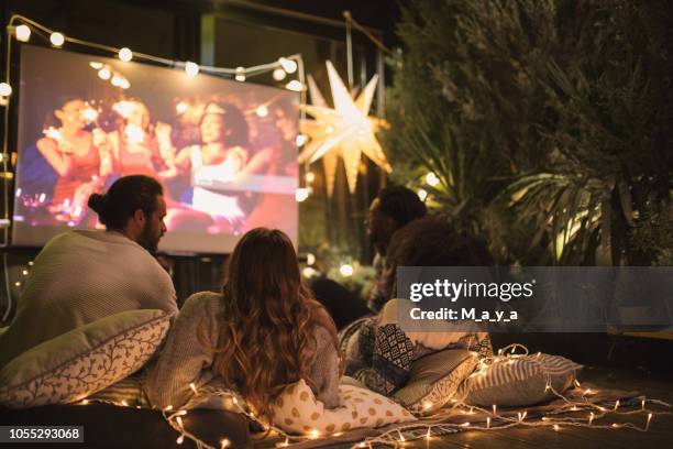 movie night at back yard - young couple at movie together imagens e fotografias de stock