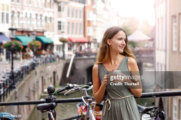 young woman enjoying coffee break - utrecht stock pictures, royalty-free photos & images