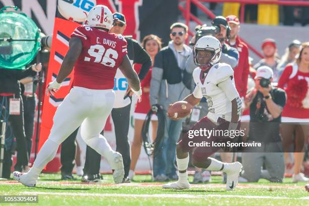 Bethune Cookman Wildcats quarterback David Israel attempts to avoid the tackle of Nebraska Cornhuskers defensive lineman Carlos Davis during the game...