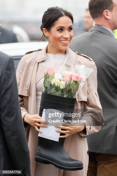 Meghan, Duchess of Sussex recieves flowers in boot from fans during 'Walkabout' on October 30, 2018 in Auckland, New Zealand. The Duke and Duchess of...