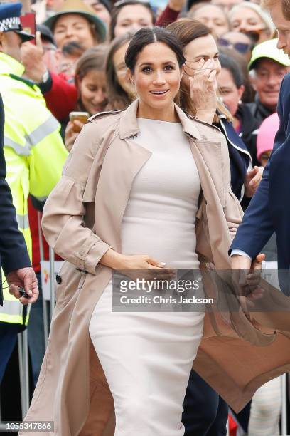 Meghan, Duchess of Sussex seen wlaking holding baby bump whilst Prince Harry, Duke of Sussex and Meghan, Duchess of Sussex during the 'Walkabout' on...