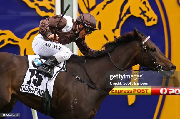 Jockey Chris Munce rides Descarado to win race 8 the BMW Caulfield Cup during Caulfield Cup Day at Caulfield Racecourse on October 16, 2010 in...