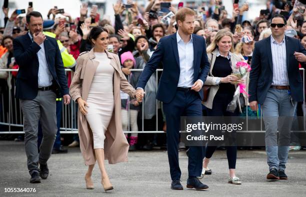 Prince Harry, Duke of Sussex and Meghan, Duchess of Sussex meet fans during a public walk along Auckland's Viaduct Harbour on October 30, 2018 in...