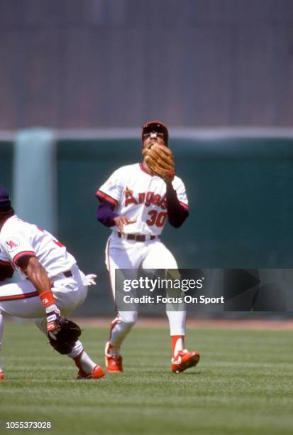 Devon White of the California Angles tracks a fly ball during an Major League Baseball game circa 1989 at Anaheim Stadium in Anaheim, California....