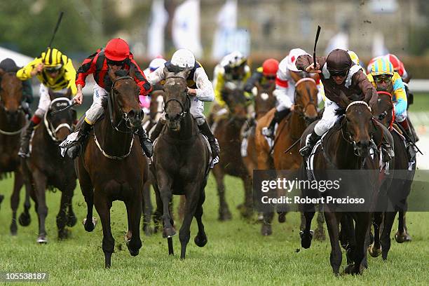 Chris Munce riding Descarado leads the field to win race Eight BMW Caulfield Cup during Caulfield Cup Day at Caulfield Racecourse on October 16, 2010...