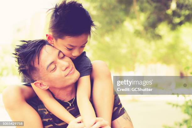 father carrying his son on the shoulder - philippines family celebration stock pictures, royalty-free photos & images