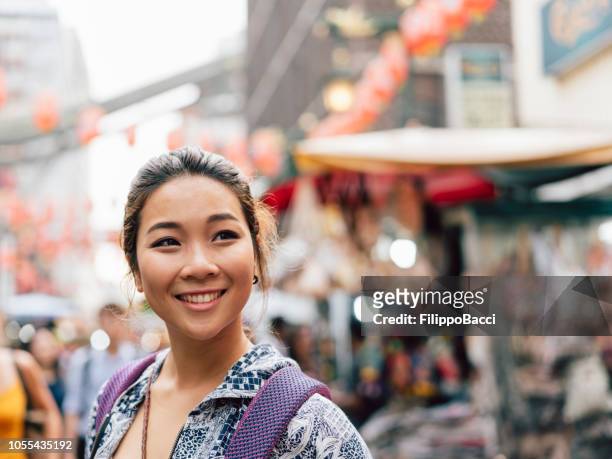 portrait of a chinese young adult woman in chinatown - chinese ethnicity stock pictures, royalty-free photos & images