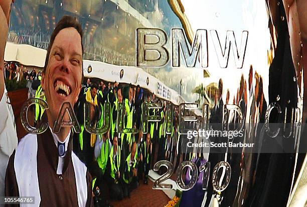 Jockey Chris Munce is reflected in the Caulfield Cup during the presentations after Descarado won race 8 the BMW Caulfield Cup during Caulfield Cup...