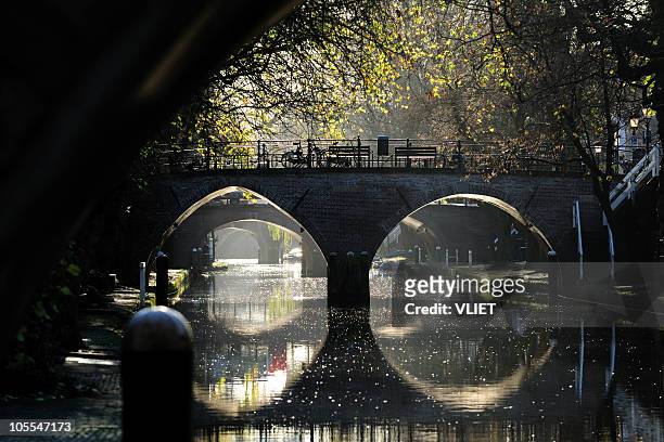 ancient bridges over canal oudegracht in utrecht the netherlands - utrecht stockfoto's en -beelden