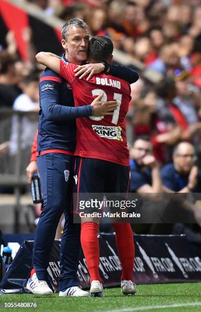 Marco Kurz coach of Adelaide United hugs Mirko Boland of Adelaide United as he comes off the ground subbed during the FFA Cup Final match between...
