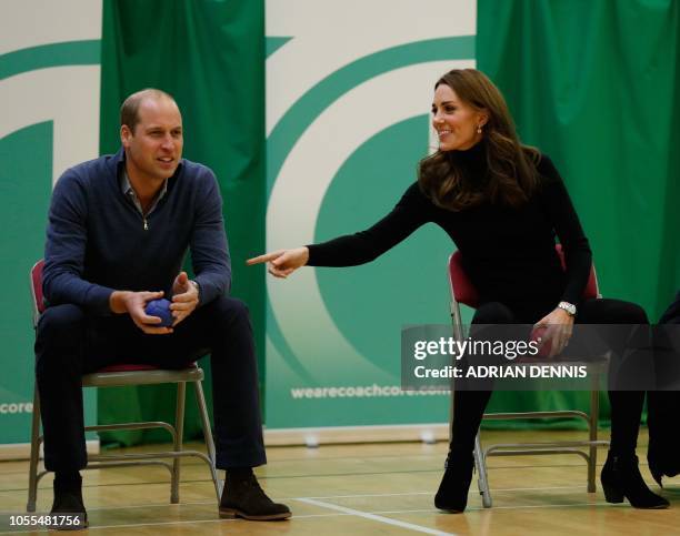 Britain's Catherine, Duchess of Cambridge, speaks to Britain's Prince William, Duke of Cambridge, as they play boccia with a participant as they join...